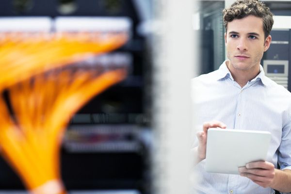 man checking computer rack